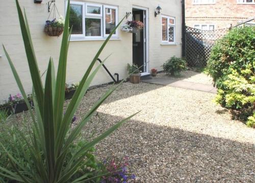a house with a plant in front of it at 9 Bromleys Court in Church Stretton