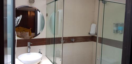 La salle de bains est pourvue d'un lavabo et d'une douche en verre. dans l'établissement Casa Lunatta, à Guanajuato