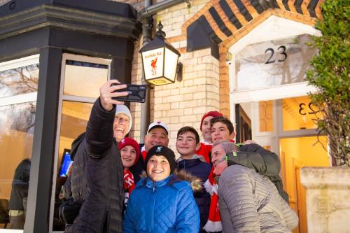 a group of people standing in front of a building at Hotel Anfield in Liverpool