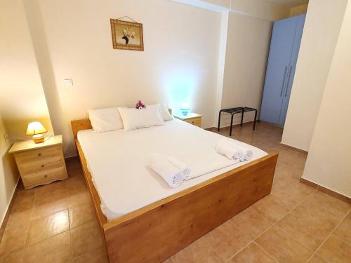 a bedroom with a large bed with white sheets at Stoupa Lefktro 9 in Kalamata