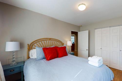 a bedroom with a white bed with red pillows at Library House in Durango