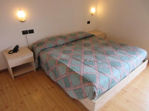 מיטה או מיטות בחדר ב-Albergo Lucia