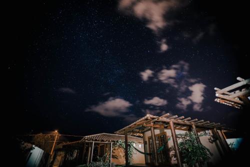 a house with a starry sky in the background at Vila Gaia Guest House in Alto Paraíso de Goiás