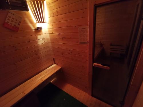 una sauna vuota con una parete in legno e una porta di Karczma KOSZARKA a Ploski
