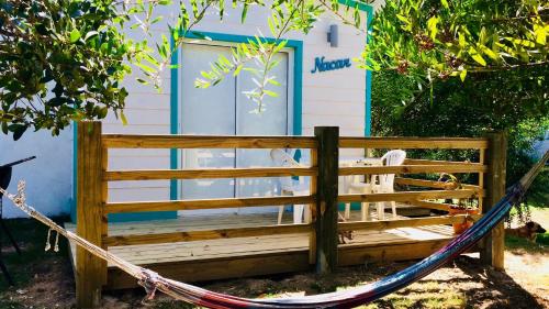 a hammock in front of a house at Posada Agua Marina in La Paloma