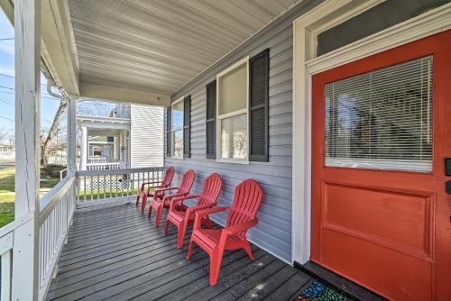 a porch with red chairs and a red door at Home with Hot Tub Less Than 2 Mi to Downtown Richmond! in Richmond