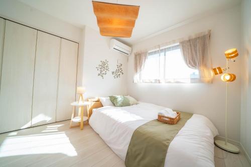 a bedroom with two beds and a window at Tachibana in Tokyo