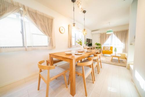 a dining room with a wooden table and chairs at Tachibana in Tokyo