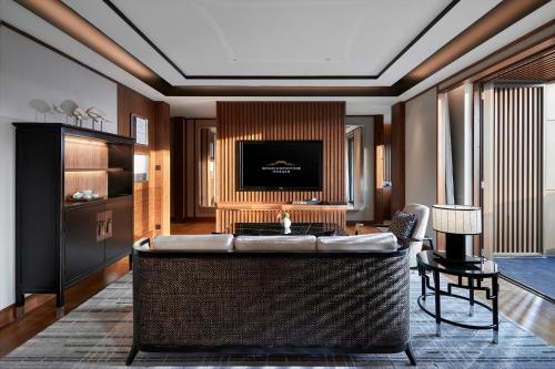a living room with a large couch and a television at Xianghu Xiaoyao Manor in Xiaoshan