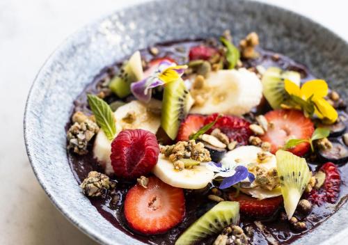 a bowl of chocolate pudding with fruit and nuts at Little National Hotel Canberra in Canberra