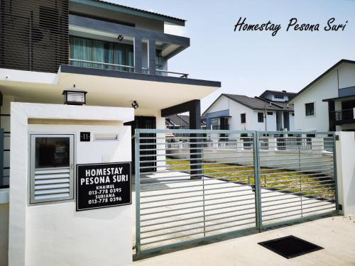 a house with a sign in front of it at Pesona Suri Homestay in Batu Pahat