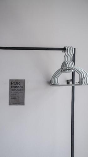 a metal light with a sign on the wall at POR Thapae Gate in Chiang Mai