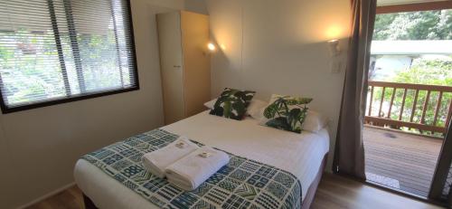 a bedroom with a bed with towels on it at Lilyponds Holiday Park in Mapleton
