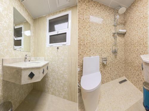 a bathroom with a toilet and a sink at Diamond Star Hotel فندق النجمة الماسية in Seeb