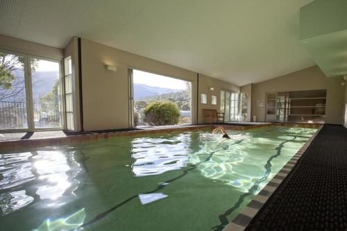 The swimming pool at or close to Four Mile HutLarge Studio Apartment in Crackenback