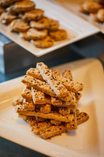 a pile of breadsticks sitting on a plate at Crowne Plaza New Delhi Rohini by IHG in New Delhi