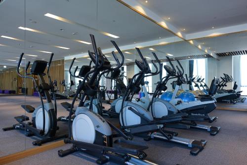 a gym with a row of exercise bikes at Grand Royal Hotel in Toufen