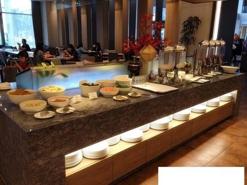 a buffet line with bowls and plates of food at Grand Royal Hotel in Toufen