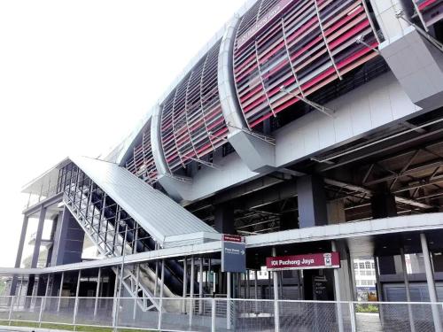 a large building with a staircase in front of it at Puchong Skypod Residence @ Hostay in Puchong