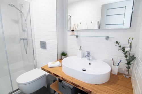 a white bathroom with a sink and a toilet at P19 Boutique Villa Badacsony in Badacsonytomaj