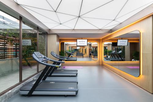 a gym with a row of chairs in a building at Novotel Xi'an The Bell Tower in Xi'an