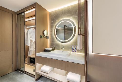 a bathroom with a sink and a mirror at Novotel Xi'an The Bell Tower in Xi'an
