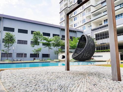 a large tire sculpture in front of a building at Puchong Skypod Residence @ Hostay in Puchong
