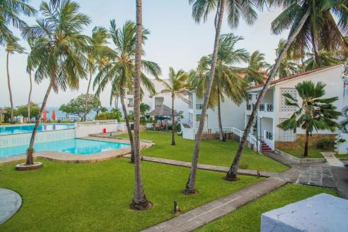 uitzicht op het zwembad en de palmbomen bij Nyali Beach Holiday Resort in Nyali