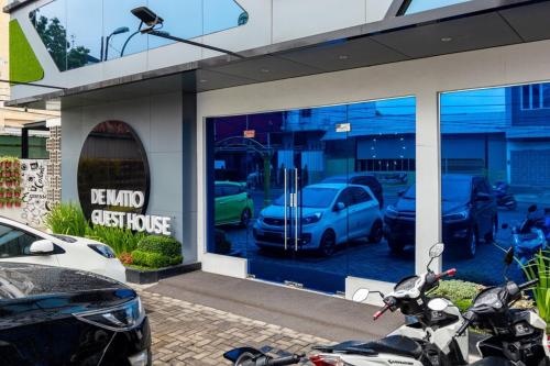 a dealership with parked cars in the window at RedDoorz Premium near Centre Point Mall Medan in Medan