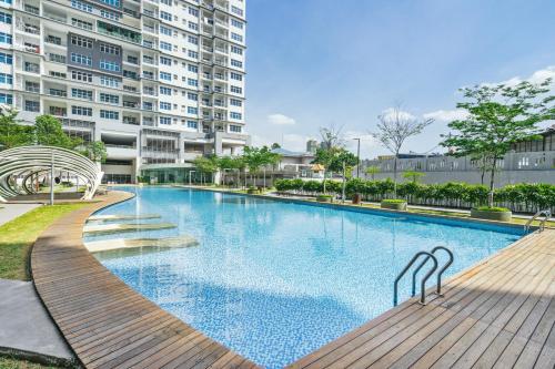 a large swimming pool in front of a building at Puchong Skypod Residence @ Hostay in Puchong