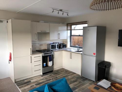 a kitchen with white cabinets and a stove top oven at Lancaster in Boston