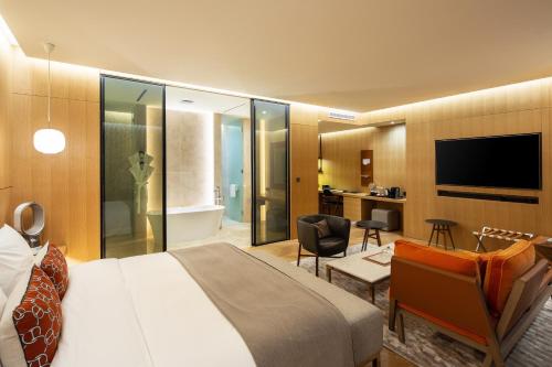 
a hotel room with a bed, table, chairs and a television at Hotel28 Myeongdong in Seoul
