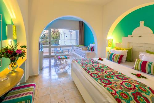 a hotel room with a bed and a living room at Splash World Venus Beach in Hammamet
