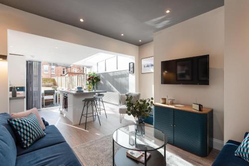 a living room with a blue couch and a table at Cherry Orchard in Shrewsbury