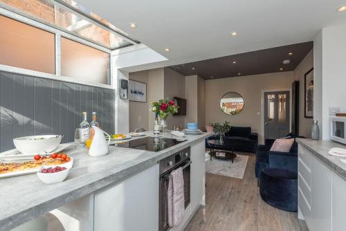 a kitchen with a counter and a living room at Cherry Orchard in Shrewsbury