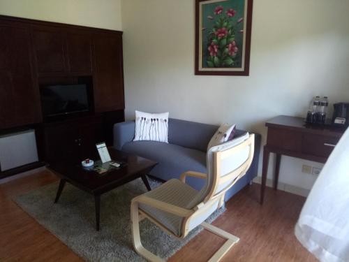 a living room with a couch and a table at The Royale Krakatau in Cilegon