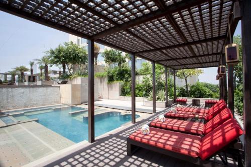 an outdoor patio with a couch and a pool at Hyatt Regency Amritsar Hotel & Spa in Amritsar