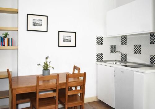 a kitchen with a table and chairs and a sink at Roma Resort Termini in Rome