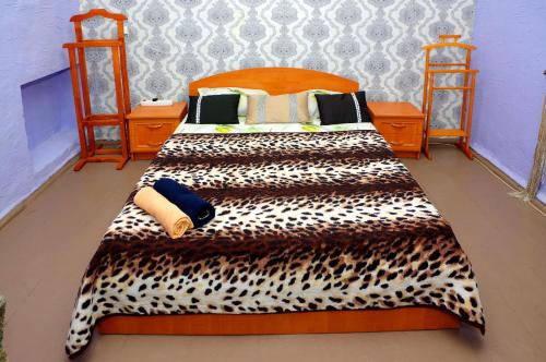 a bedroom with a bed with a leopard print bedspread at Успенский in Odesa