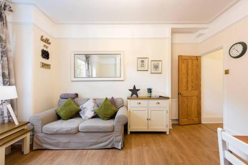 a living room with a couch and a mirror at Bikki Apartments - 2 Bedroom in Harrow