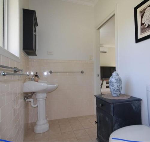 a bathroom with a sink and a toilet at Little Britton in Wingham