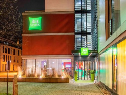 a store front of a building with a ups store at ibis Styles Karlsruhe Ettlingen in Ettlingen