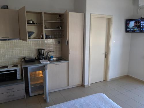 a kitchen with a sink and a stove top oven at Kapsouli Square Komotini in Komotini