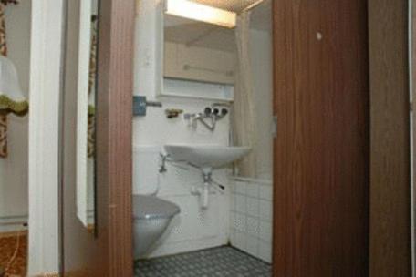 a bathroom with a sink and a toilet in it at Funny Farm Backpackers in Interlaken