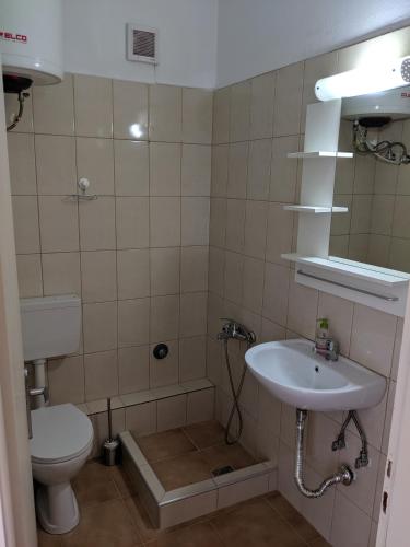 a bathroom with a toilet and a sink at Kapsouli Square Komotini in Komotini