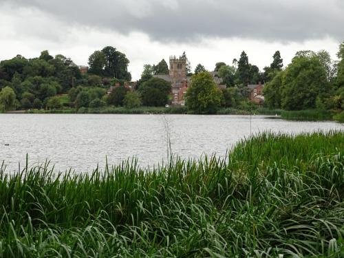 a view of a lake with a castle in the background at Ellesmere Hotel in Ellesmere