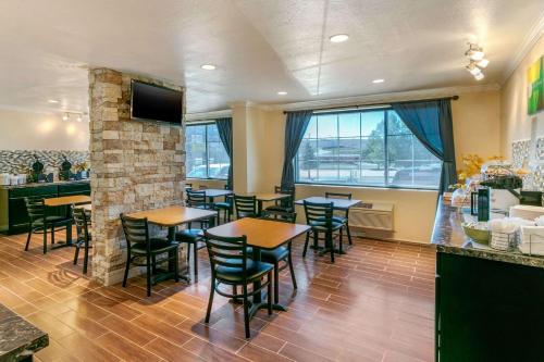a restaurant with tables and chairs and a bar at Quality Inn Rawlins I-80 in Rawlins