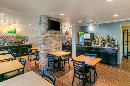 a restaurant with tables and chairs and a bar at Quality Inn Rawlins I-80 in Rawlins