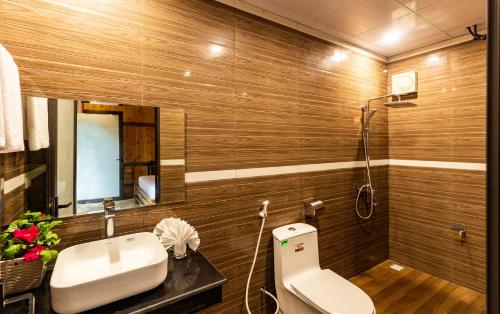 a bathroom with a toilet and a sink and a mirror at Trang An Moon Garden Homestay in Ninh Binh
