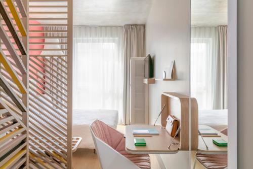 
a living room filled with furniture and a window at OKKO Hotels Toulon Centre in Toulon
